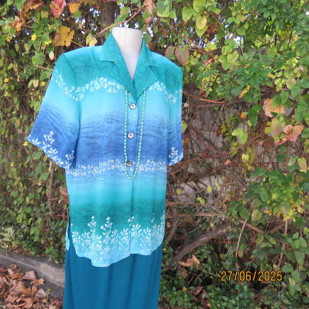 Horizontal patterned teal green and blue-white floral short sleeve top. Size 38