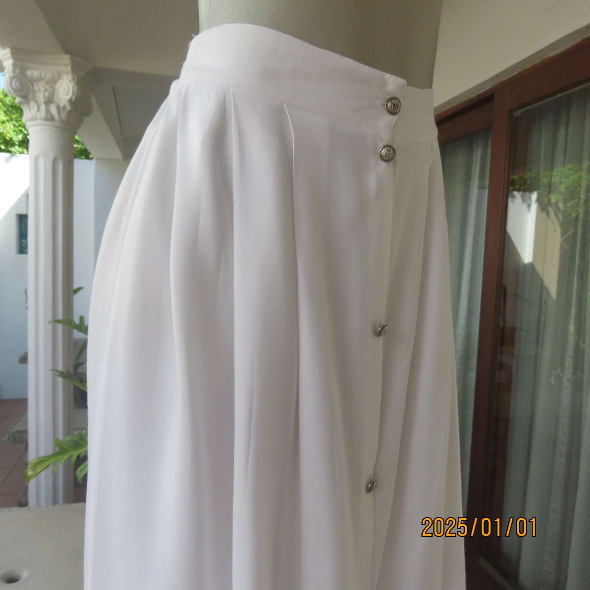 Cool white button down viscose calf length skirt. Knife pleats on front.Elasticated back. Size 36.