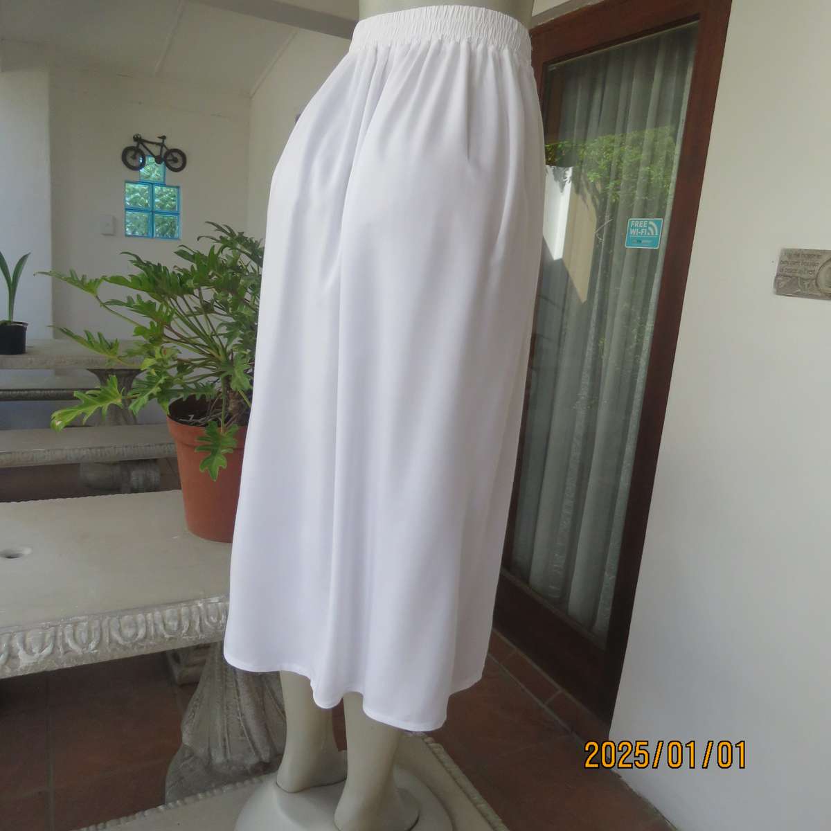 Cool white button down viscose calf length skirt. Knife pleats on front.Elasticated back. Size 36.