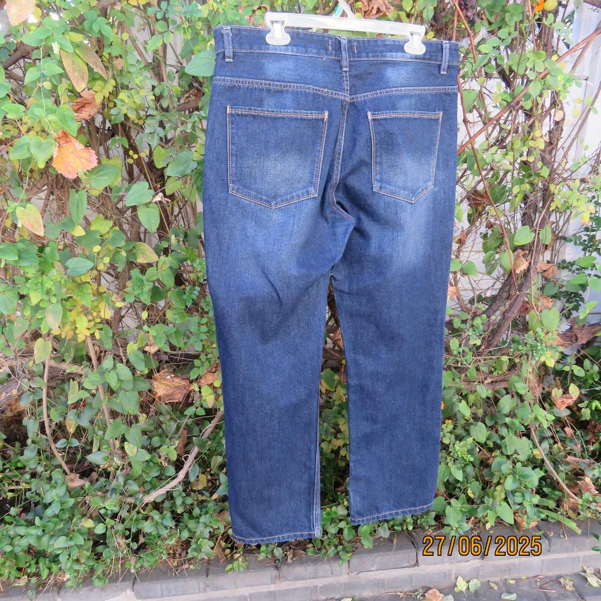 Men's blue denim polycotton straight legged jeans in size 36.