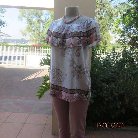 White with pink and light brown floral design slip over top. Wide elasticated collar. Size 36