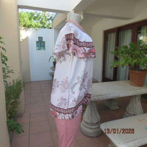 White with pink and light brown floral design slip over top. Wide elasticated collar. Size 36