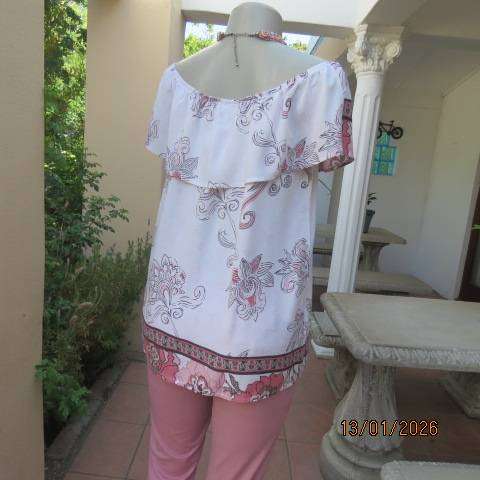 White with pink and light brown floral design slip over top. Wide elasticated collar. Size 36