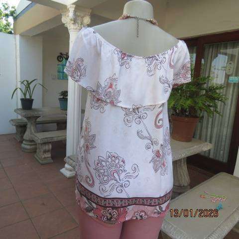 White with pink and light brown floral design slip over top. Wide elasticated collar. Size 36