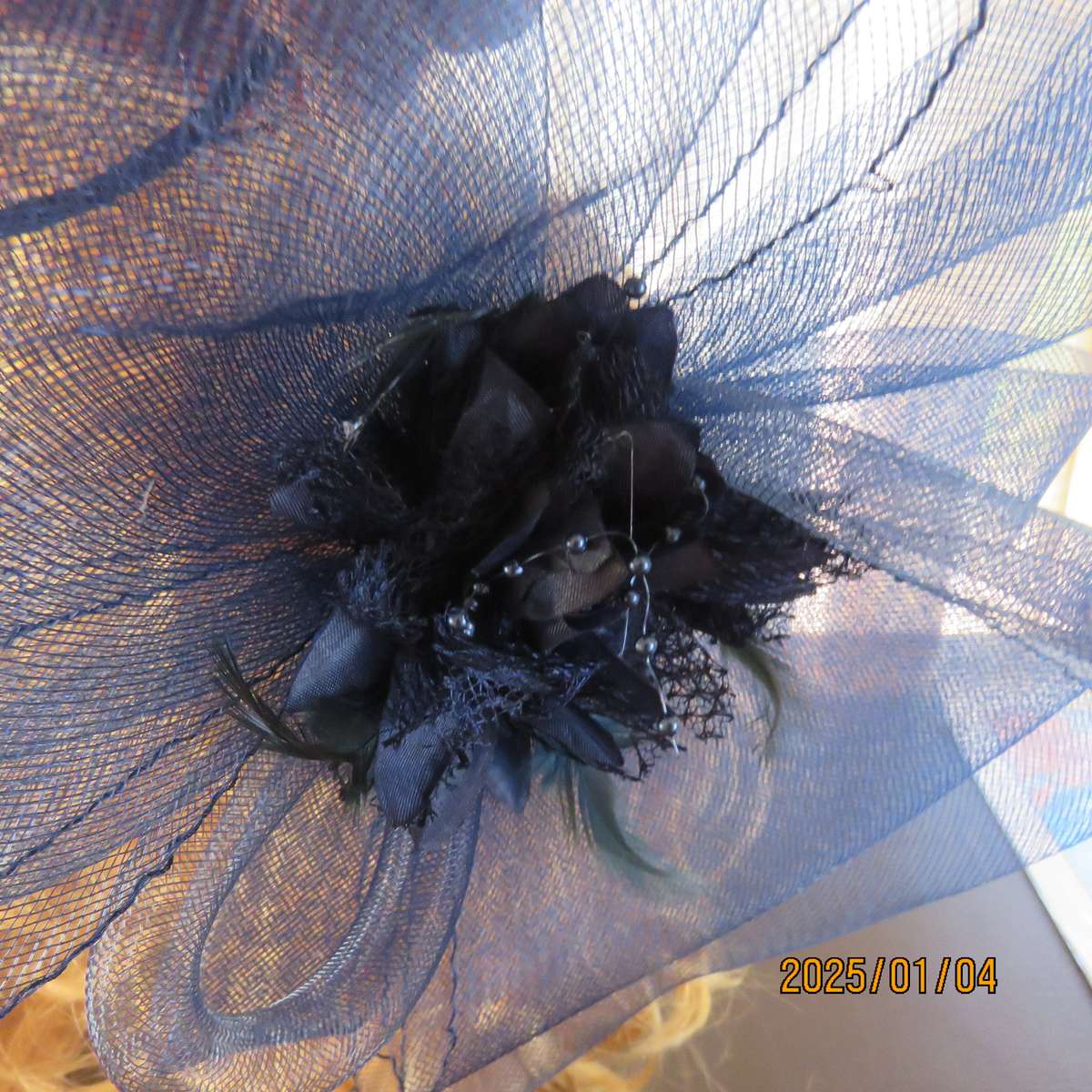 Make a statement wearing this navy double bow mesh fascinator with flower and feathers. New item