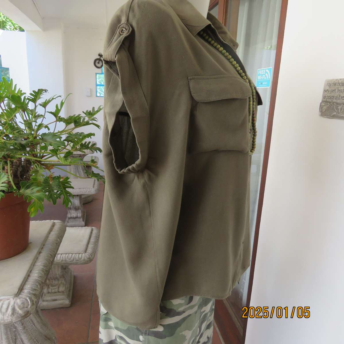 Army green viscose sleeveless button down top. Shirt collar. Flap pockets. Small epaulettes.Size 40.