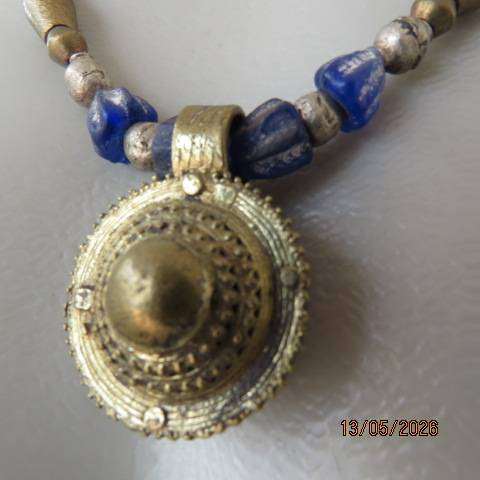 Ethnic beaded necklace with blue and gold beads and copper pendant