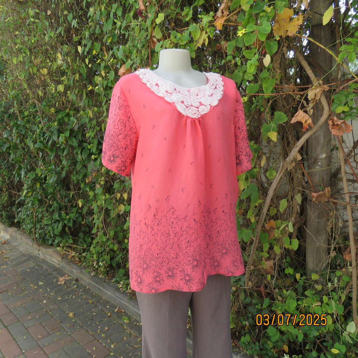 Crimson slip over size 42 short sleeve top with dull black print. 100% Rayon.