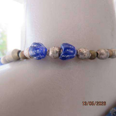 Ethnic beaded necklace with blue and gold beads and copper pendant