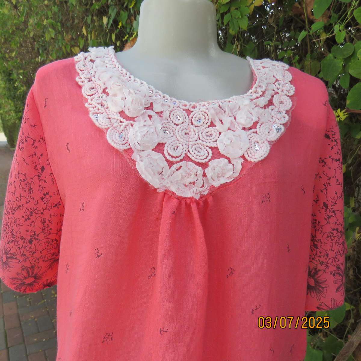 Crimson slip over size 42 short sleeve top with dull black print. 100% Rayon.
