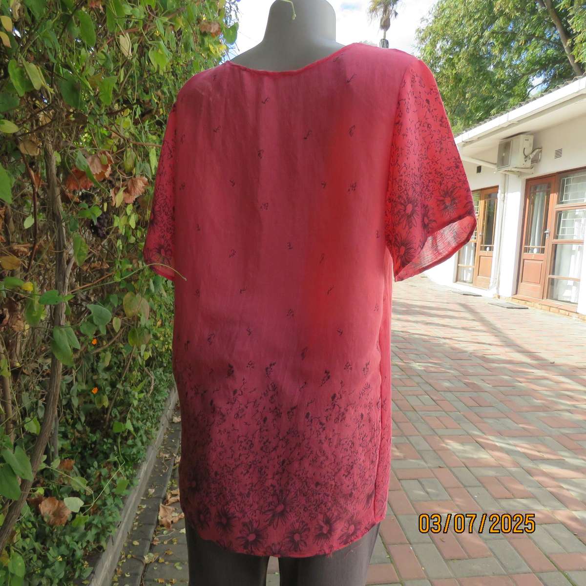 Crimson slip over size 42 short sleeve top with dull black print. 100% Rayon.