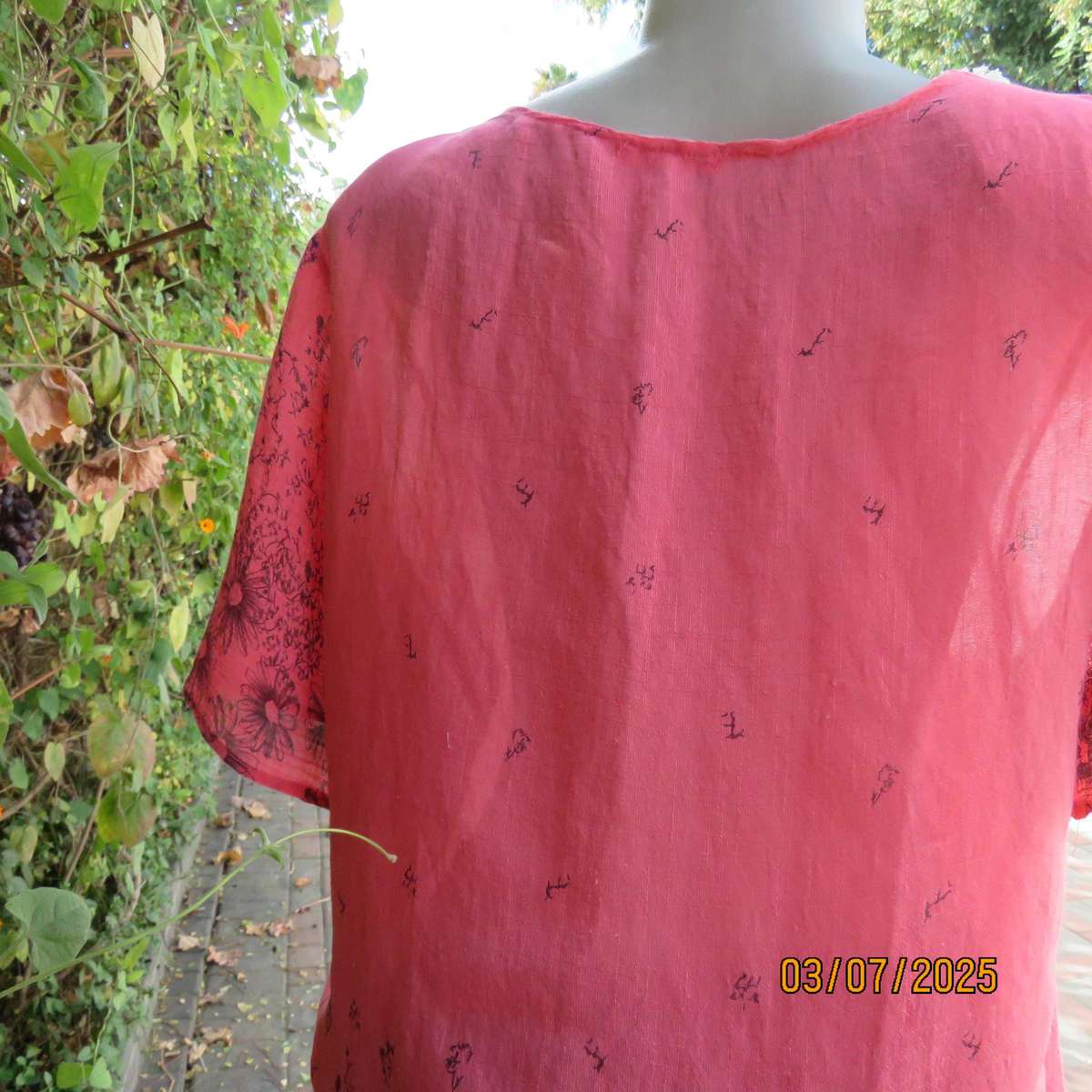 Crimson slip over size 42 short sleeve top with dull black print. 100% Rayon.