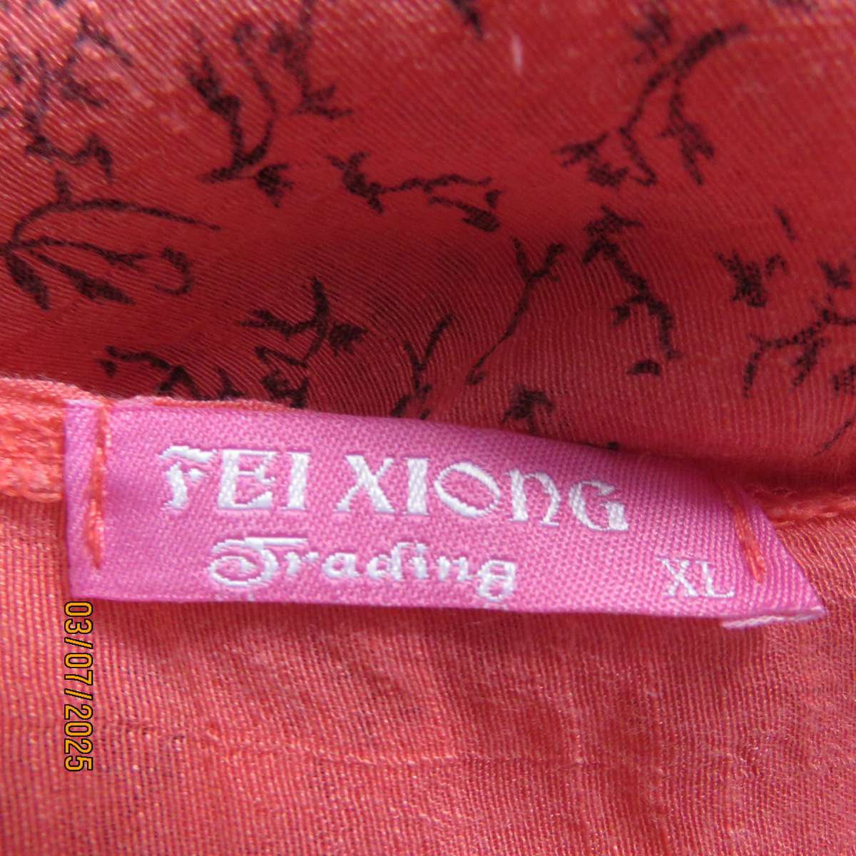 Crimson slip over size 42 short sleeve top with dull black print. 100% Rayon.