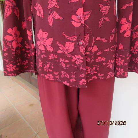Maroon long sleeve polyester top with crimson flowers and banded collar. Size 34