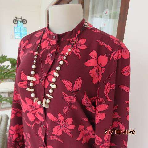 Maroon long sleeve polyester top with crimson flowers and banded collar. Size 34