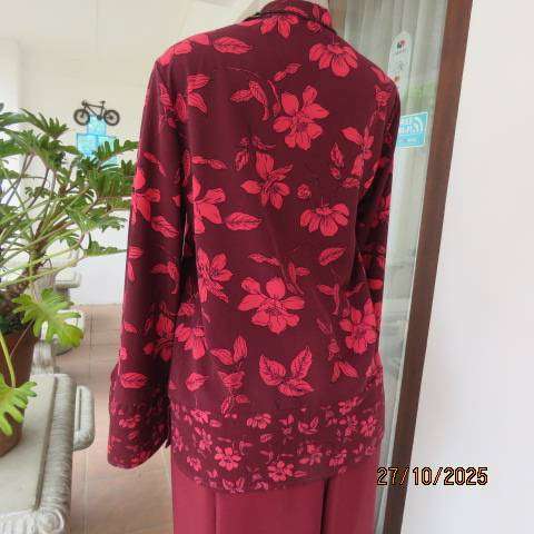 Maroon long sleeve polyester top with crimson flowers and banded collar. Size 34