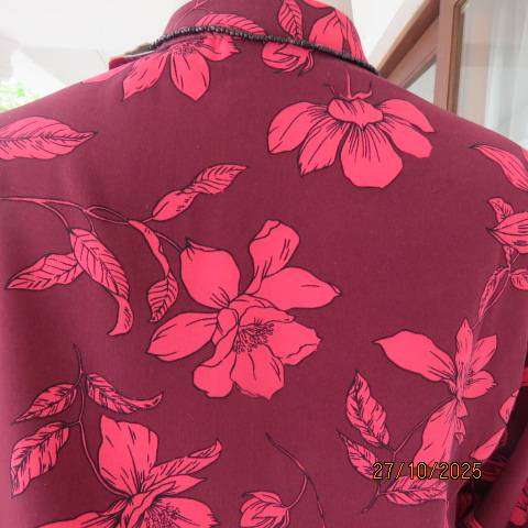 Maroon long sleeve polyester top with crimson flowers and banded collar. Size 34