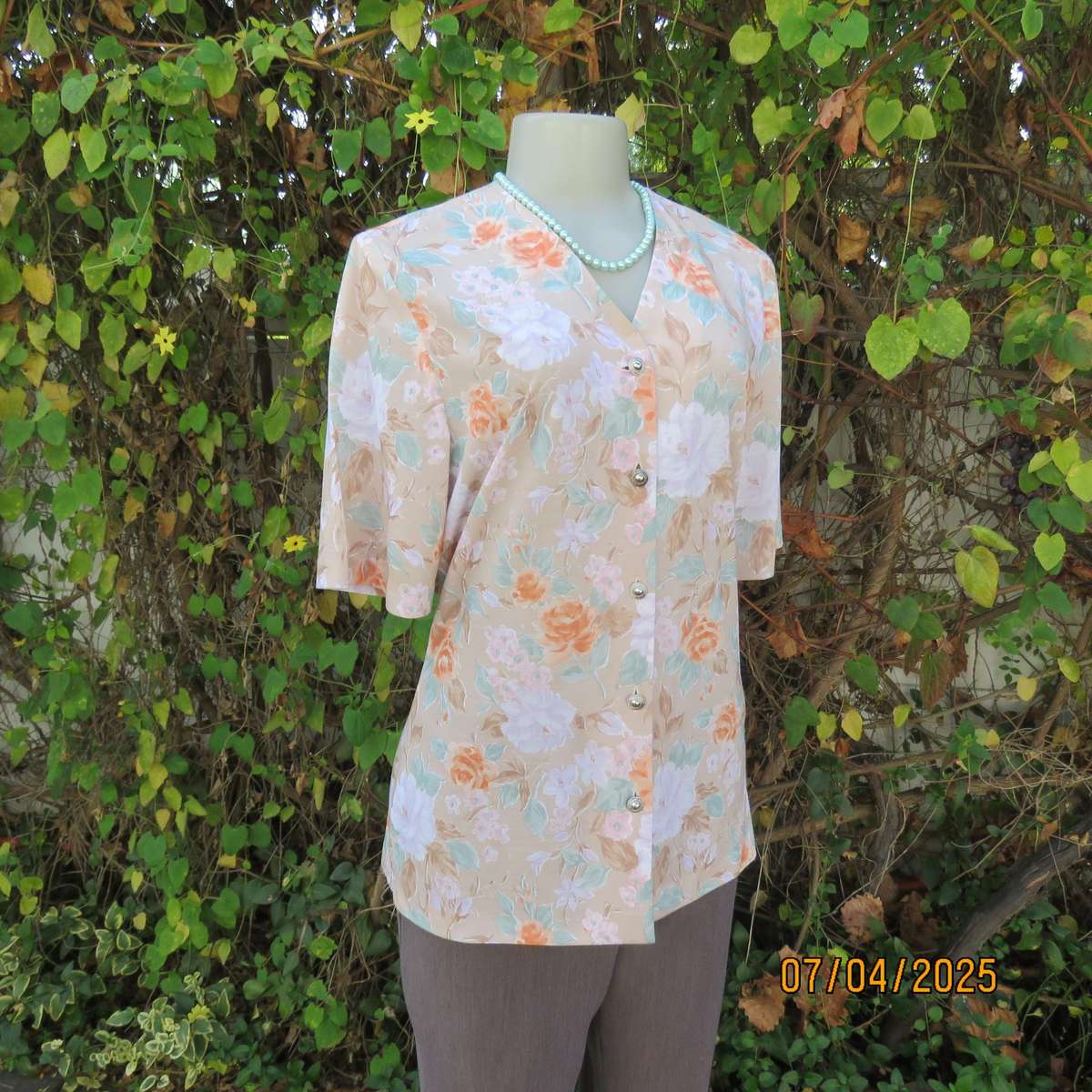 WOOLWORTHS oatmeal colour V front button down top. With peach-lilac flowers. Size 34
