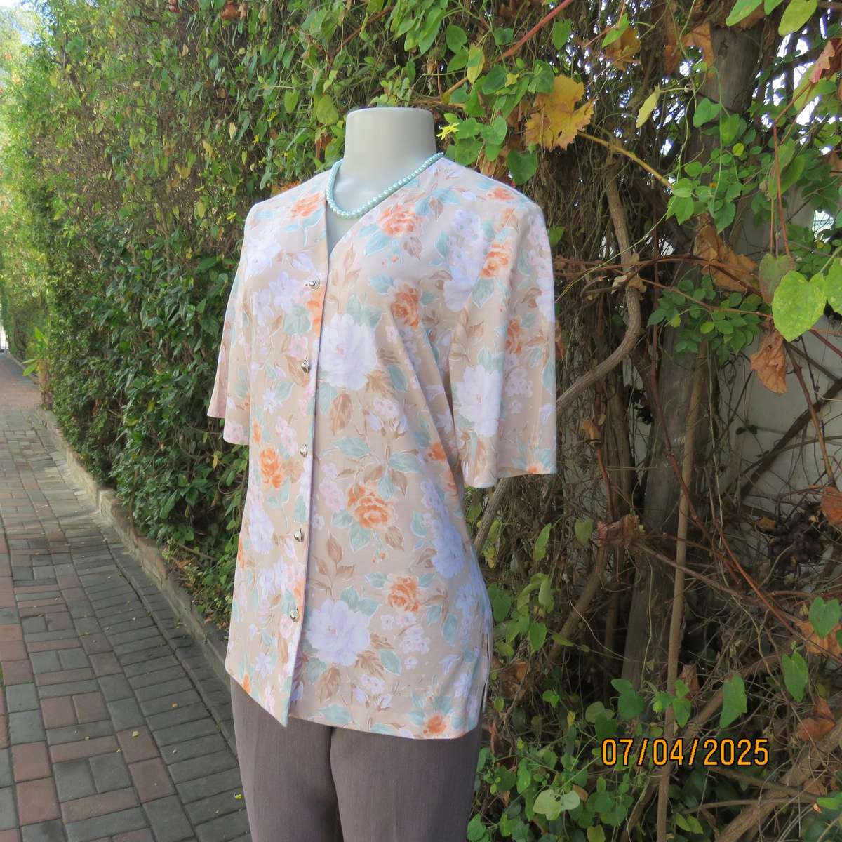 WOOLWORTHS oatmeal colour V front button down top. With peach-lilac flowers. Size 34