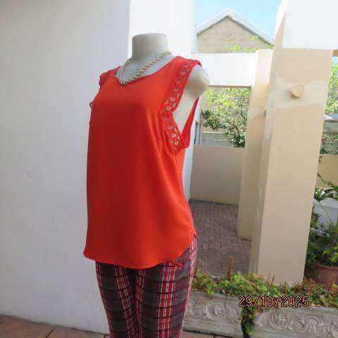 Bright red sleeveless slip over polyester top with lace decoration. Size 36