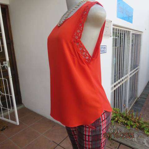 Bright red sleeveless slip over polyester top with lace decoration. Size 36