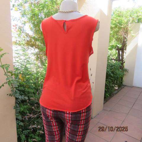 Bright red sleeveless slip over polyester top with lace decoration. Size 36