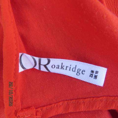 Bright red sleeveless slip over polyester top with lace decoration. Size 36