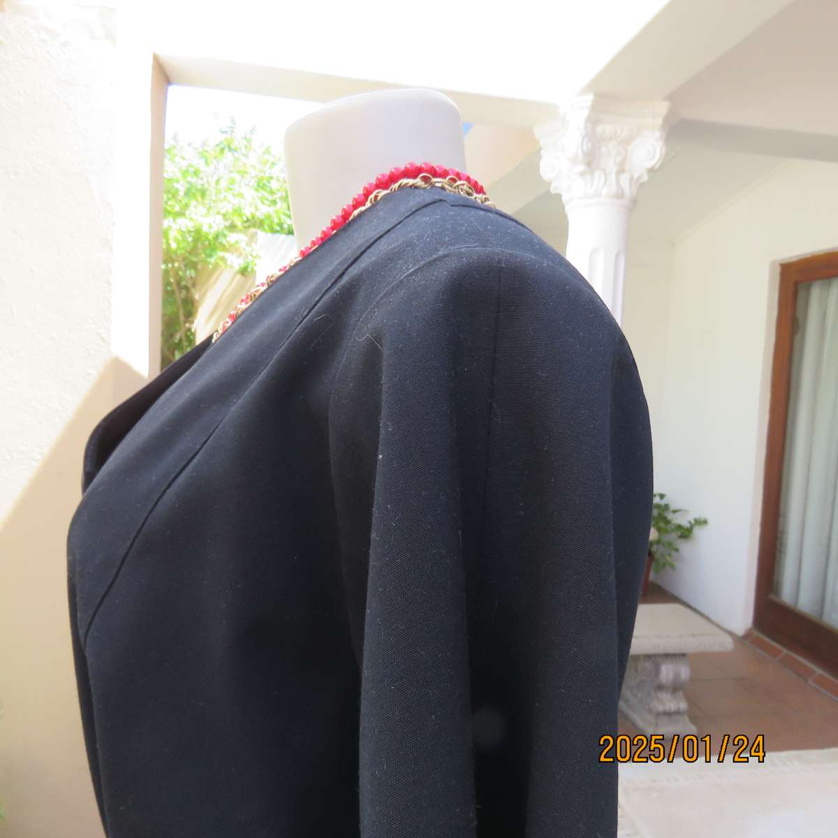 Elegant black short sleeve firm polycotton collarless jacket. Four button closure. Size 40. As new