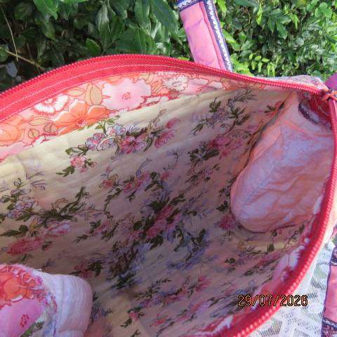 Pink patterned fabric bag with zip closure - rounded side design with straps