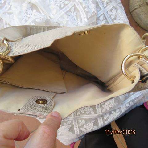 Miss Cassidy gold shoulder bag with gold buckle decoration and vertical front zip
