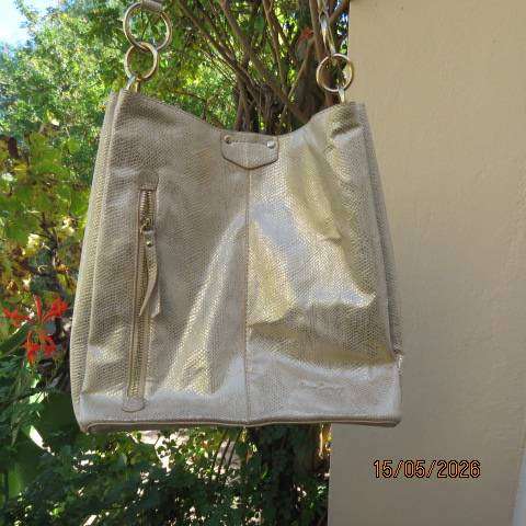 Miss Cassidy gold shoulder bag with gold buckle decoration and vertical front zip