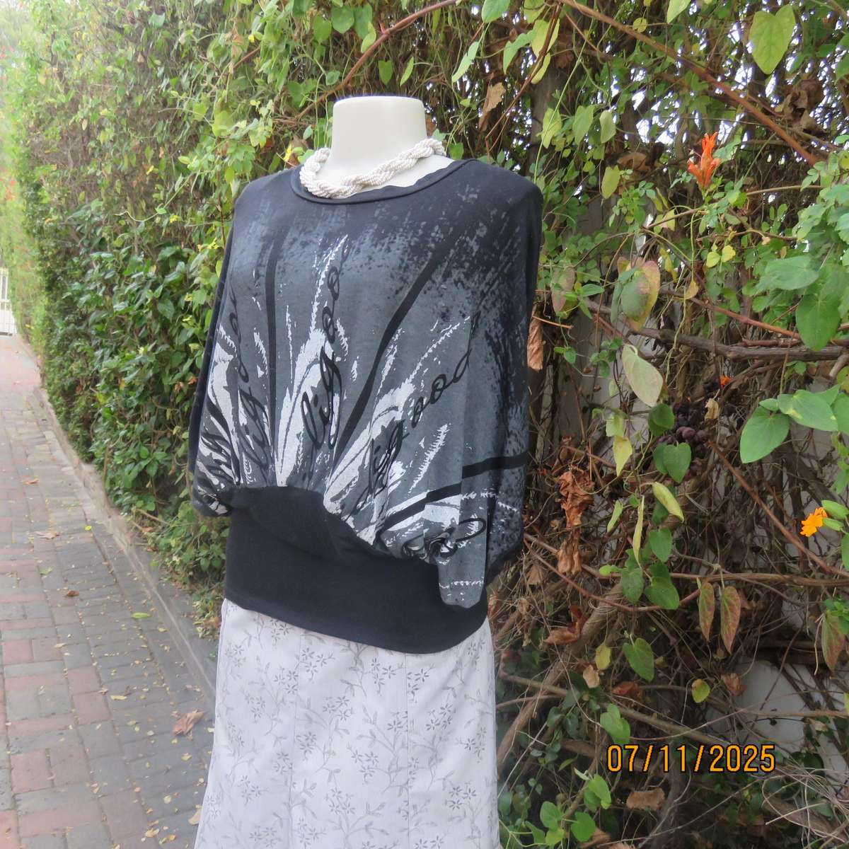 Black stretch viscose top with kimono style short sleeves. Front silver-grey print. Size 40