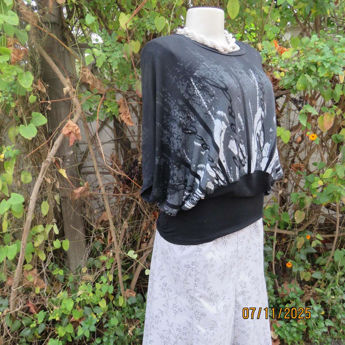 Black stretch viscose top with kimono style short sleeves. Front silver-grey print. Size 40