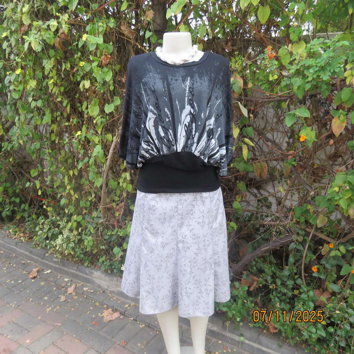 Black stretch viscose top with kimono style short sleeves. Front silver-grey print. Size 40