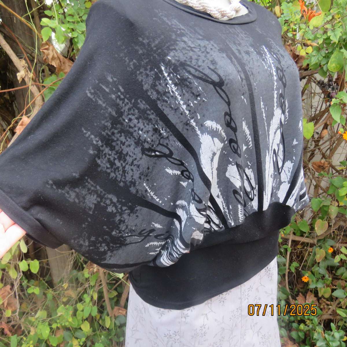 Black stretch viscose top with kimono style short sleeves. Front silver-grey print. Size 40