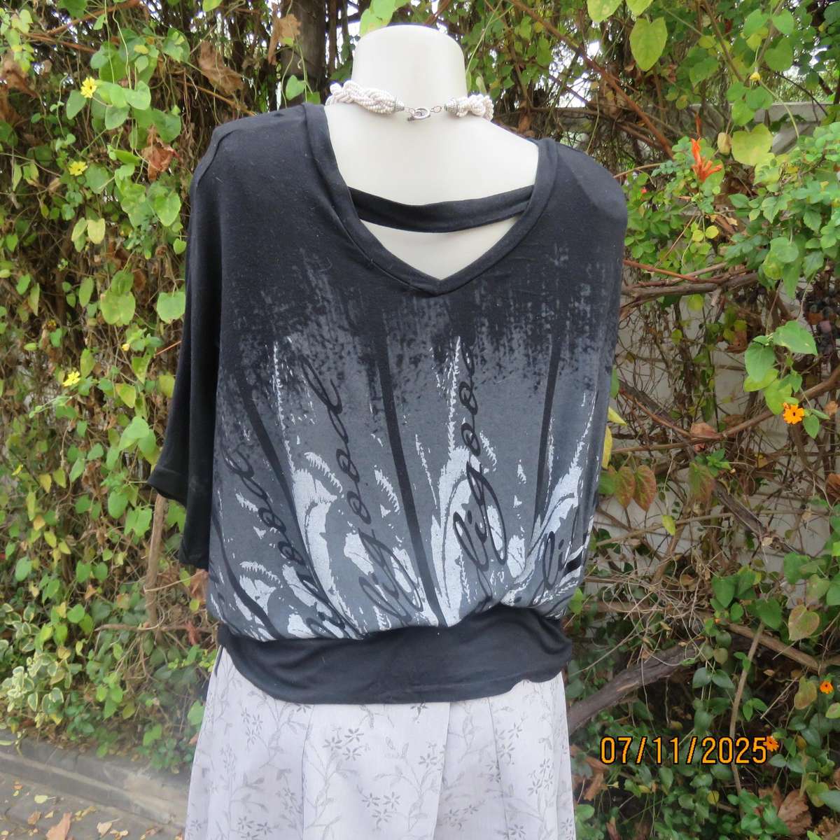 Black stretch viscose top with kimono style short sleeves. Front silver-grey print. Size 40