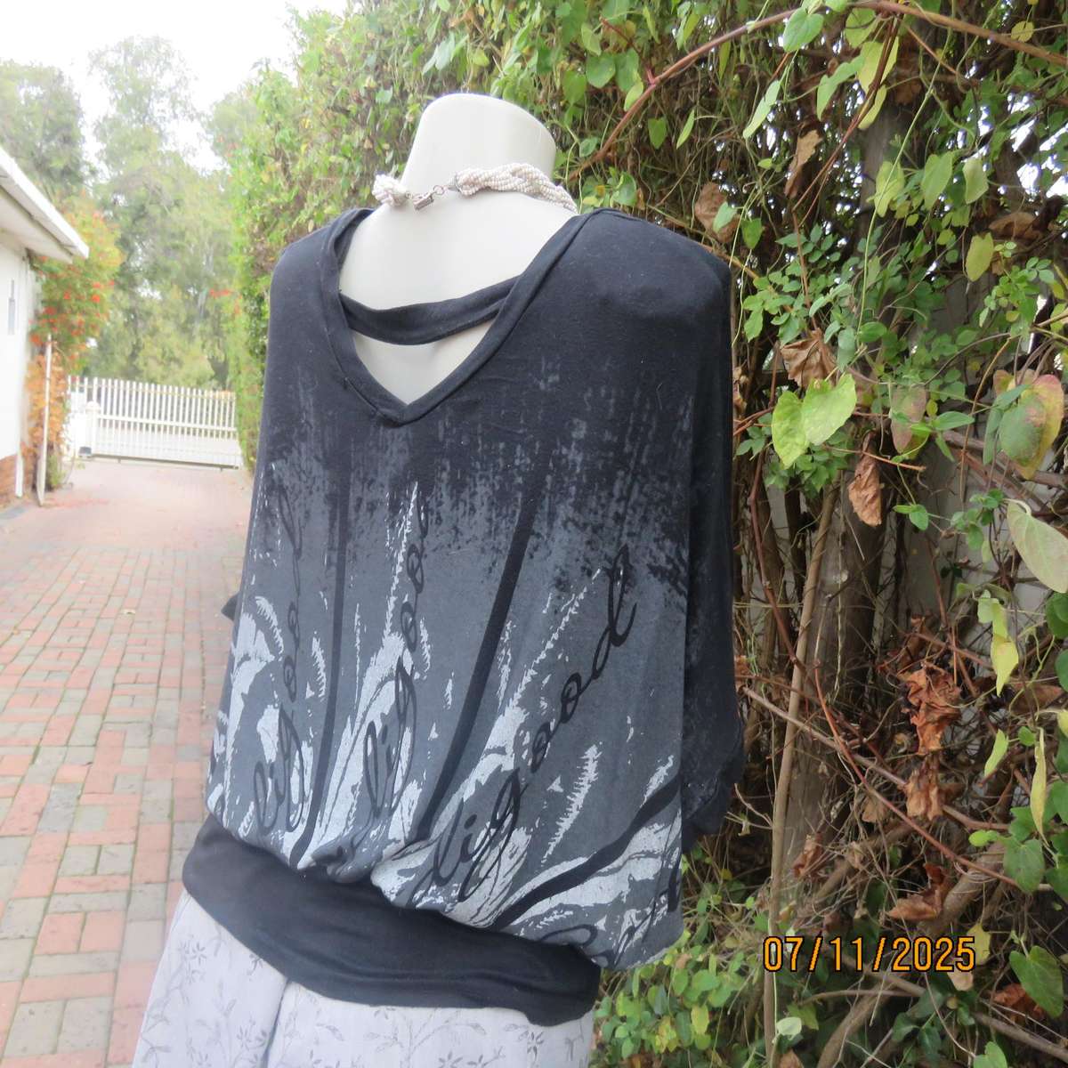 Black stretch viscose top with kimono style short sleeves. Front silver-grey print. Size 40