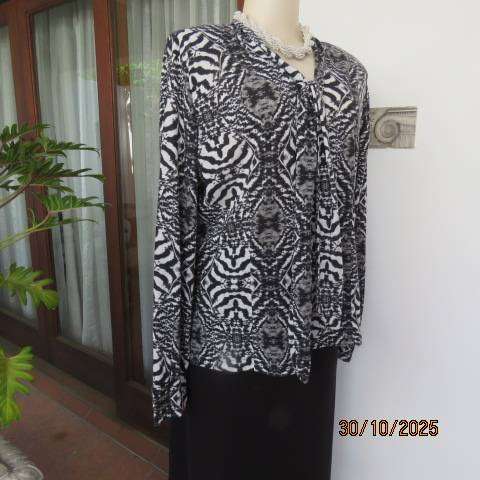 Animal print long sleeve top in black-white-grey. Warm soft polyester. Size 42