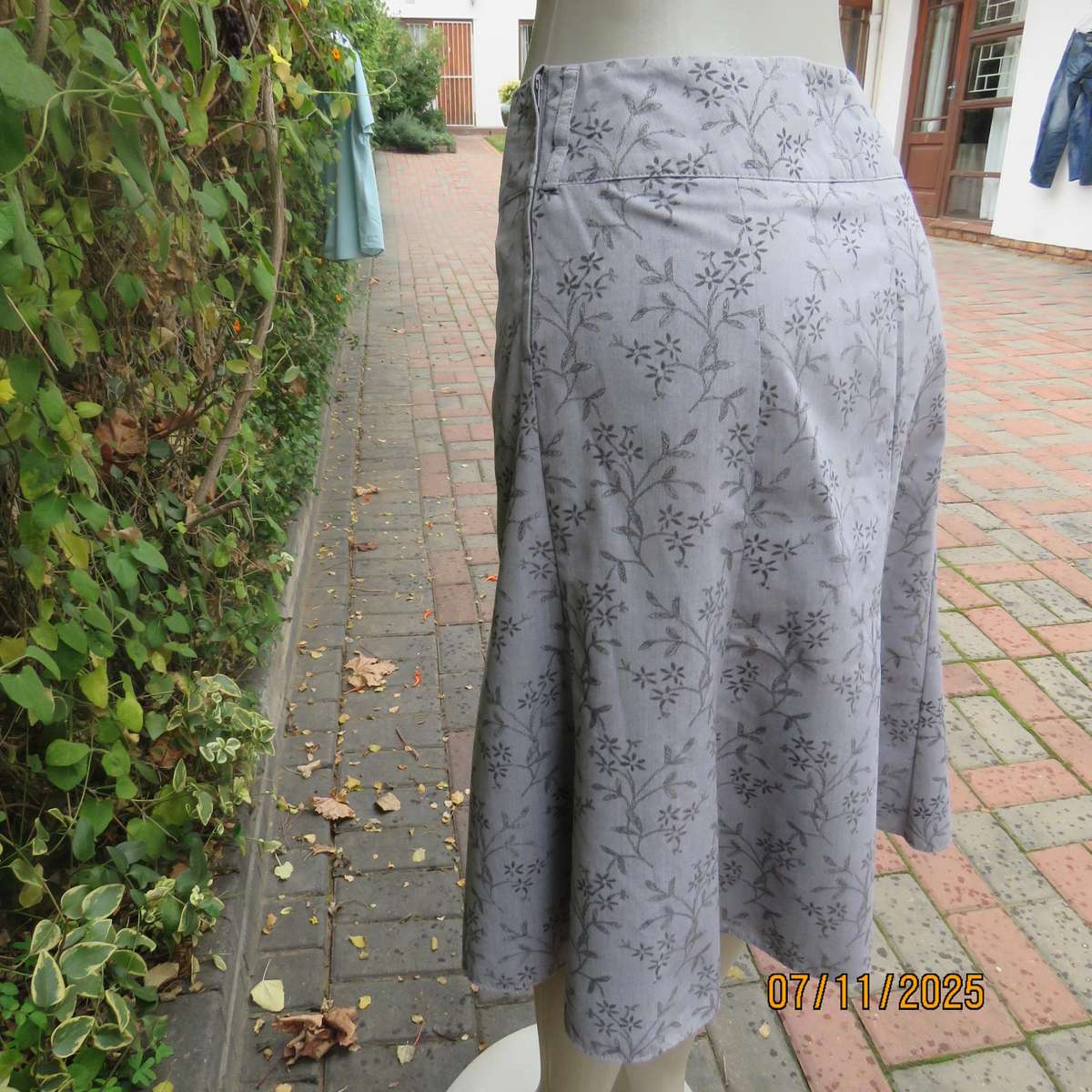 EXACT silver grey A Line paneled skirt with darker grey tiny flowers. Size 38.