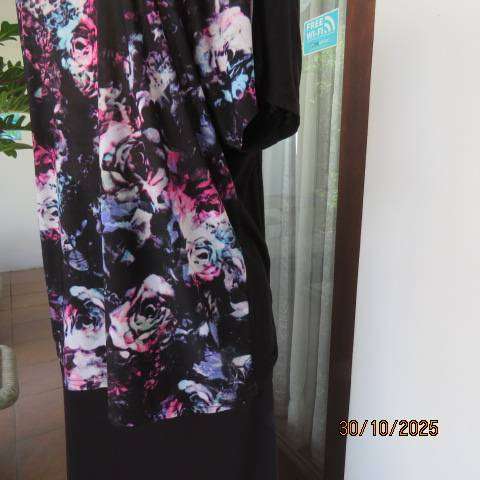 Black soft polyester-viscose stretch top with floral front. Chain neck decoration. Size 42