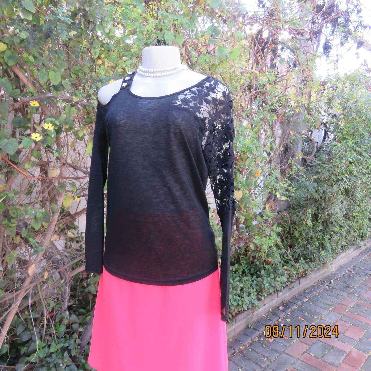 Gorgeous black day/evening wear top. One sleeve partly lace.Other naked shoulder. Size 36.As new