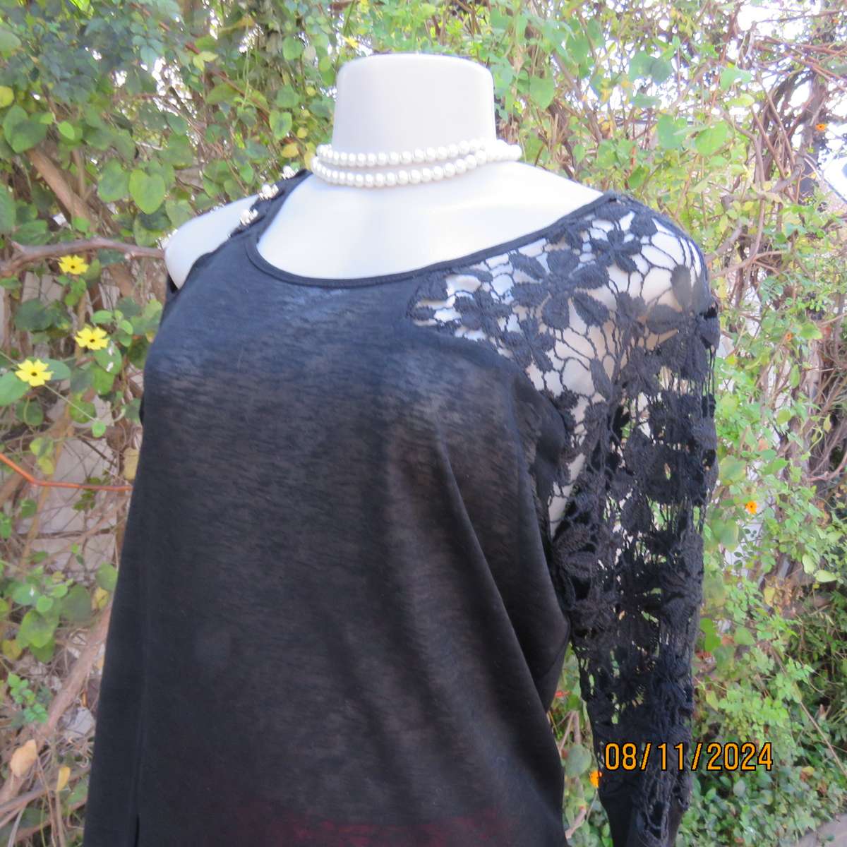 Gorgeous black day/evening wear top. One sleeve partly lace.Other naked shoulder. Size 36.As new