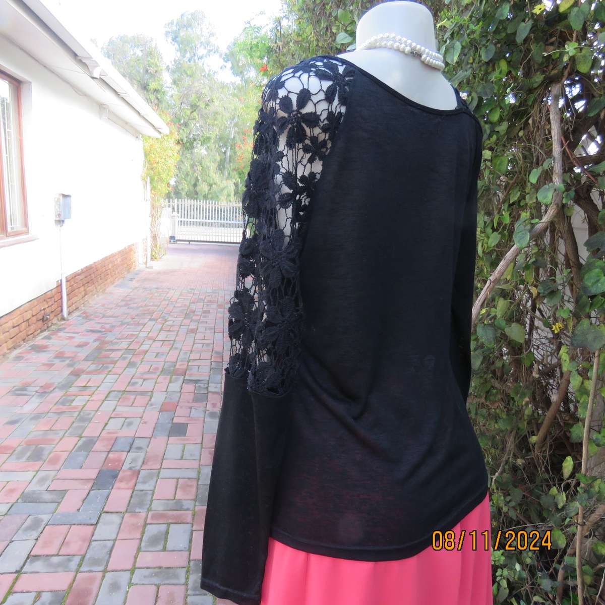 Gorgeous black day/evening wear top. One sleeve partly lace.Other naked shoulder. Size 36.As new