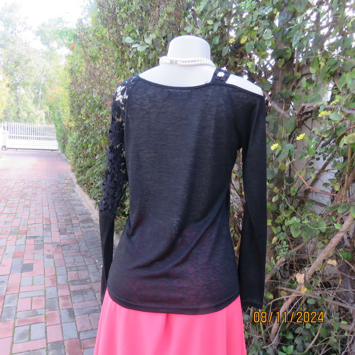 Gorgeous black day/evening wear top. One sleeve partly lace.Other naked shoulder. Size 36.As new
