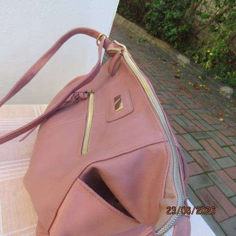 Pink PVC sling bag with side bags and front zipped compartments polyester lining