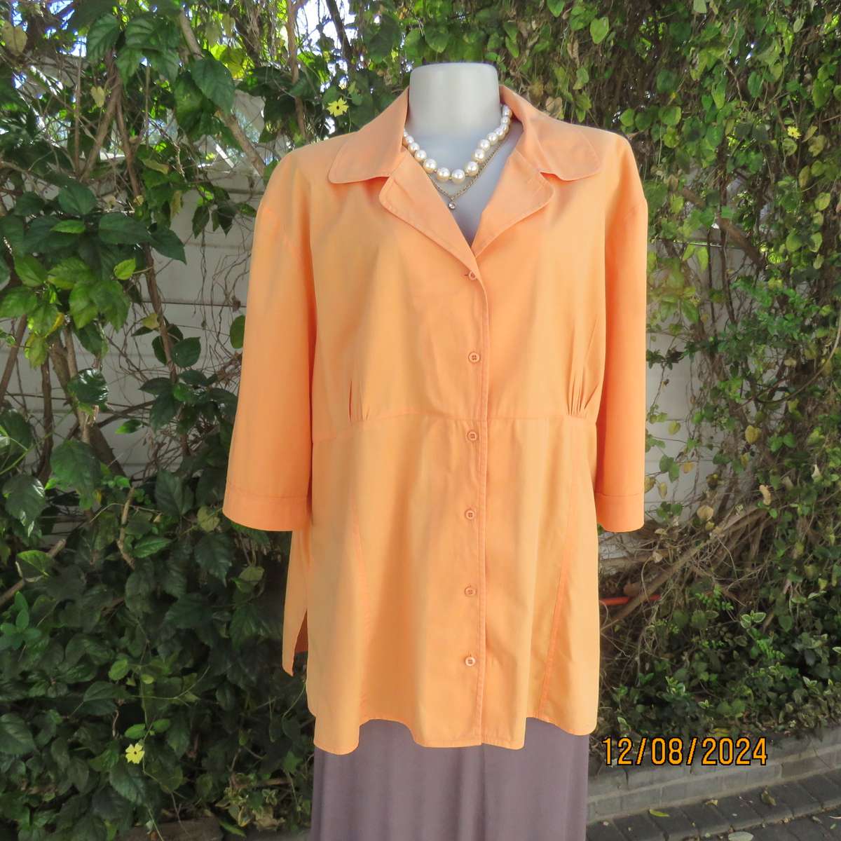 Easy to wear papaya colour button down top with gathered empire front. Size 50by DONATELLA. As new