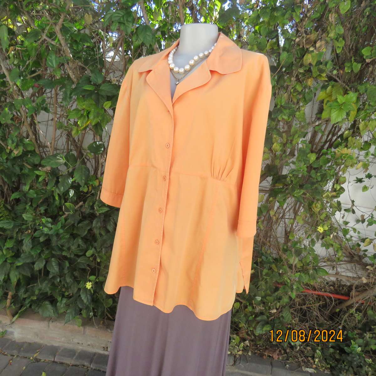 Easy to wear papaya colour button down top with gathered empire front. Size 50by DONATELLA. As new