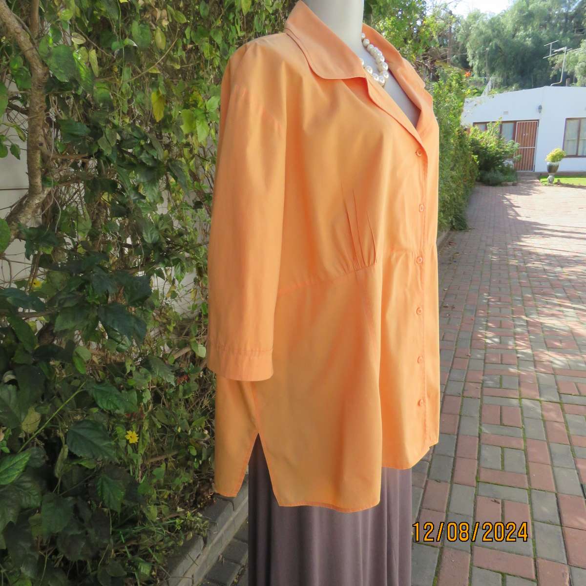 Easy to wear papaya colour button down top with gathered empire front. Size 50by DONATELLA. As new
