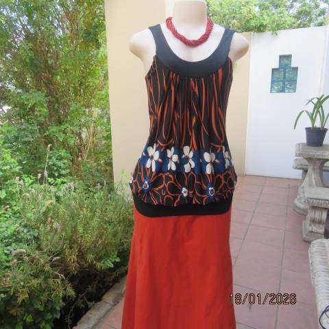 Black stretch polyester blouson style top with blue-cream-orange floral print. Wide band. Size 34