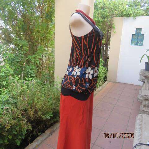 Black stretch polyester blouson style top with blue-cream-orange floral print. Wide band. Size 34